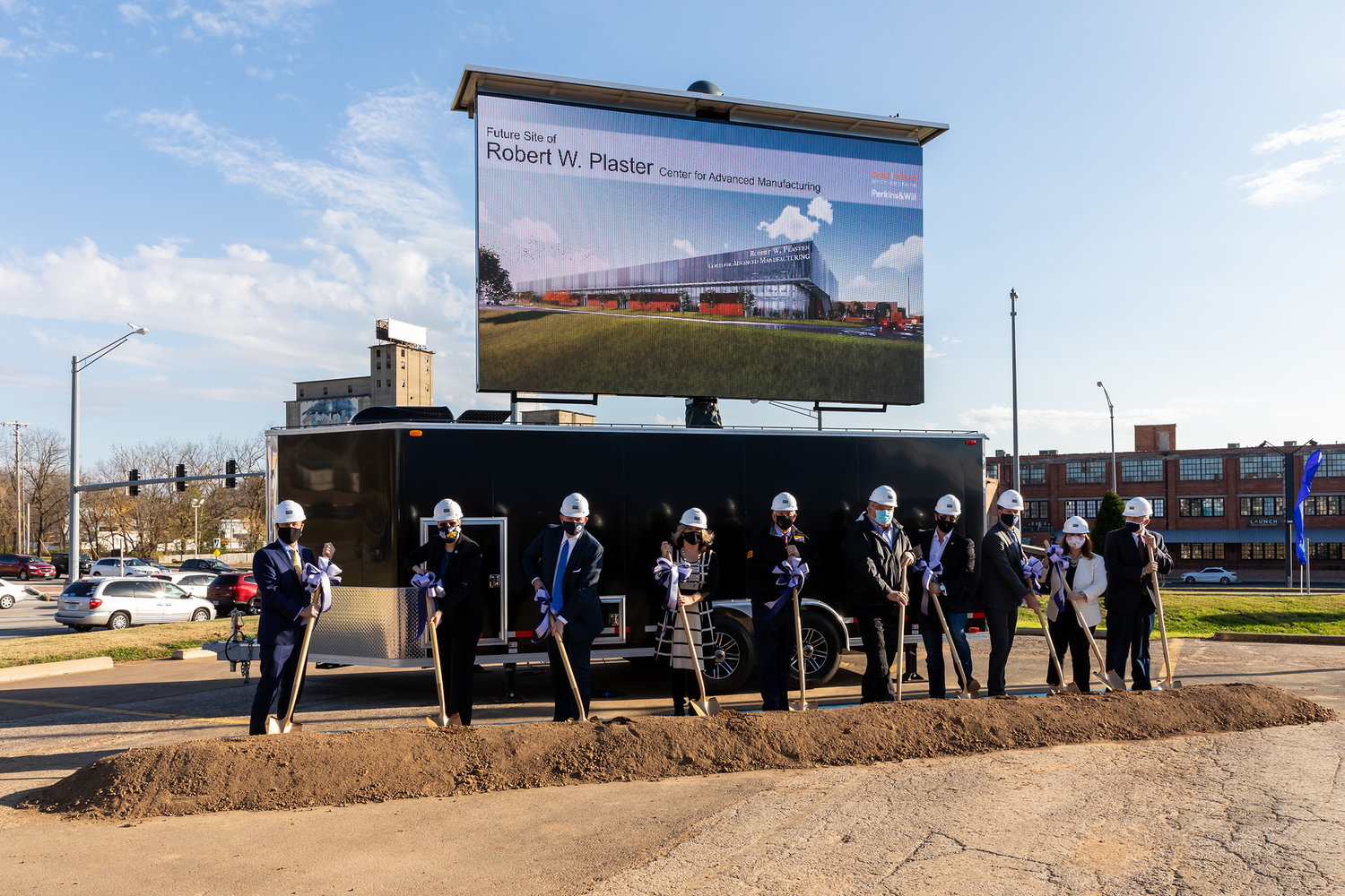 Officials, including Missouri Gov. Mike Parson, fifth from left, dig in at the Nov. 12 groundbreaking at Ozarks Technical Community College for the Robert W. Plaster Center for Advanced Manufacturing.